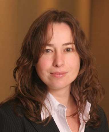 portrait of brunette woman wearing white shirt and dark coat